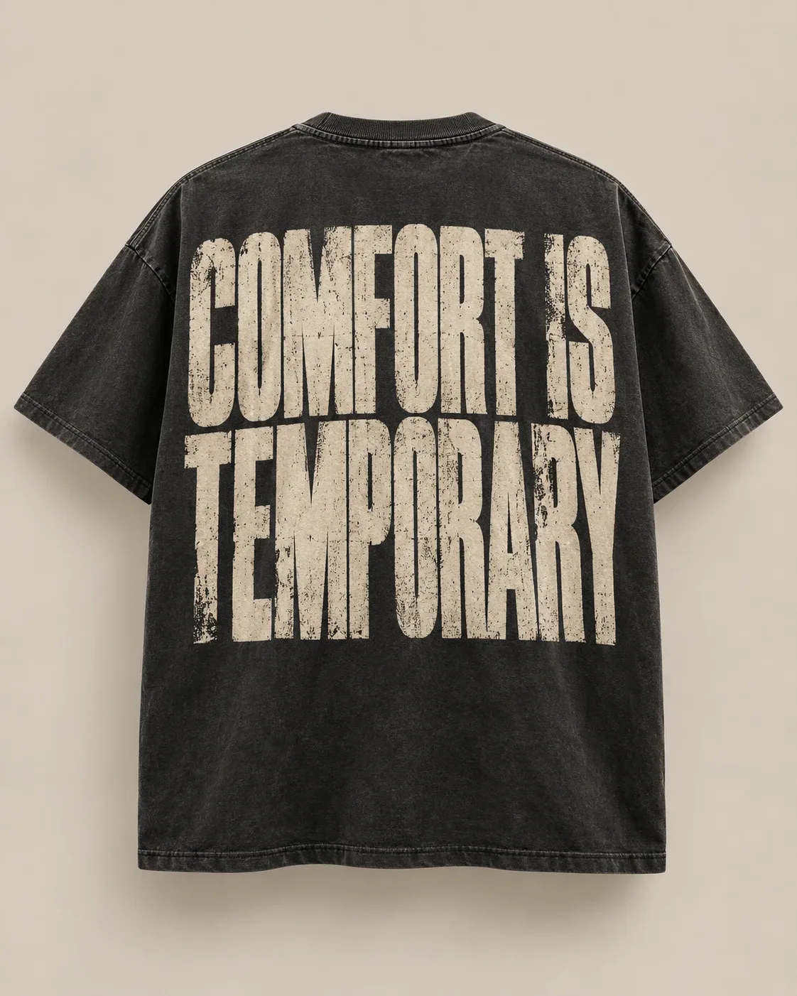 Washed black tee with a large distressed 'Comfort Is Temporary' back print.
