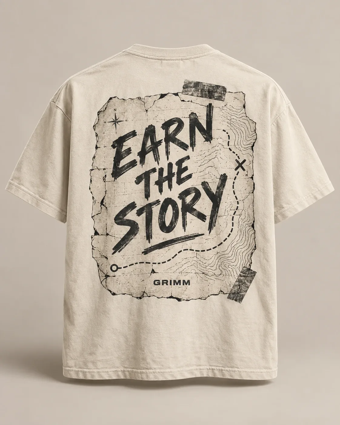 Sand tee with an 'Earn the Story' back print on a torn, taped trail map.